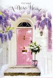At a peaceful doorstep in St Paul's Cray, a new chapter seems to be beginning under a haze of spring blossoms. The focus is a pale pink front door, softly luminous against whitewashed walls that reflect the easy, natural light of a quiet residential lane off Cray Avenue. A single shutter to one side, painted in the same blush tone, adds balance and charm, echoing the door as though the whole frontage has been thoughtfully coordinated. From above, wisteria trails downward in lush curtains of lavender and soft violet, its clusters of flowers hanging heavy and fragrant, evoking the scent and texture of established gardens found around the local area. The twining stems scrawl gently across the wall, catching the light in places and leaving others in dappled shade, giving the scene depth and a sense of stillness. Resting directly on the doorstep is a compact yet generous floral arrangement in a simple grey metal bucket. Inside, velvety white and cream roses are gathered tightly together, some blooms fully open, others just unfurling, their centres creamy and inviting. Fresh green foliage is threaded between them, separating and framing each flower so that every rose stands out. Around the base of the bucket is a soft pink ribbon tied neatly into a bow, a small but deliberate detail that echoes the door and unifies the whole composition. This doorway tableau feels like a housewarming moment captured in time, suggesting a gift delivered to a new home in St Paul's Cray, filled with hope, privacy, and the quiet promise that this fresh space will soon be filled with life, laughter, and everyday comforts.